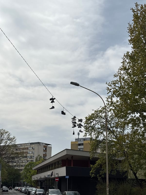 Witness documents everyday Belgrade street scenes, hanging shoes, shopping center