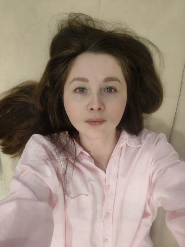 Woman in pink shirt resting indoors, residential setting