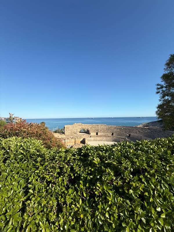 Tourists explore Roman ruins and Mediterranean coastline in sunny Tarragona