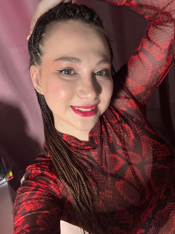 Woman takes selfies in red snakeskin top in Saratov