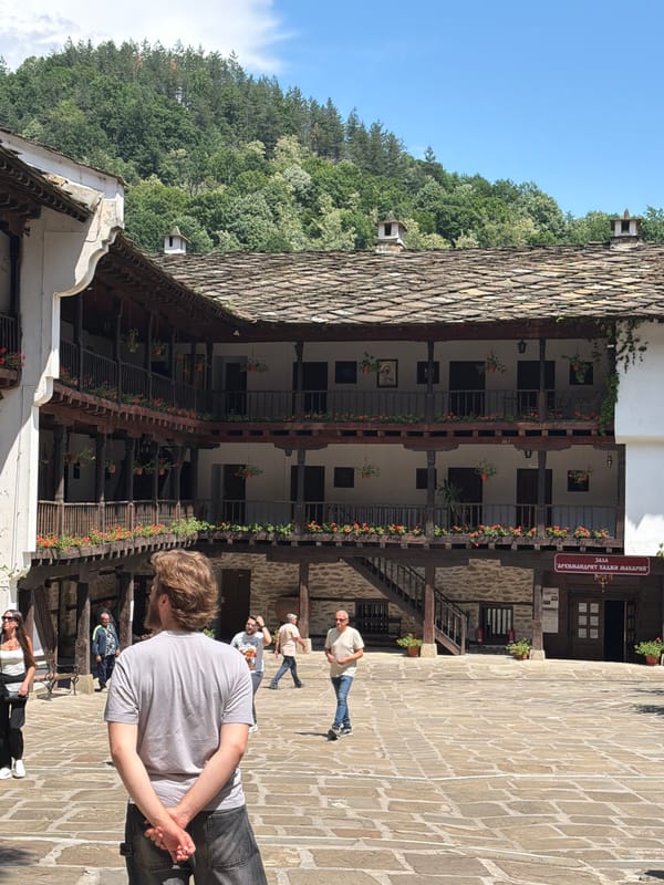 Visitor documents historic Troyan Monastery architecture in Bulgaria