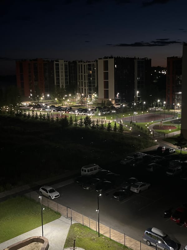 Modern Chelyabinsk apartment complex at night, multiple angles