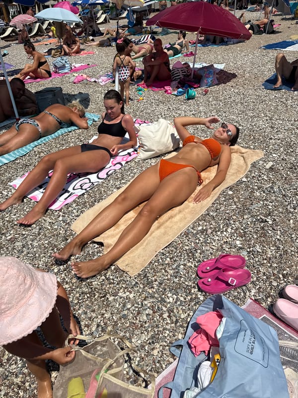 Busy summer morning on the pebble beach in Boreti, Montenegro