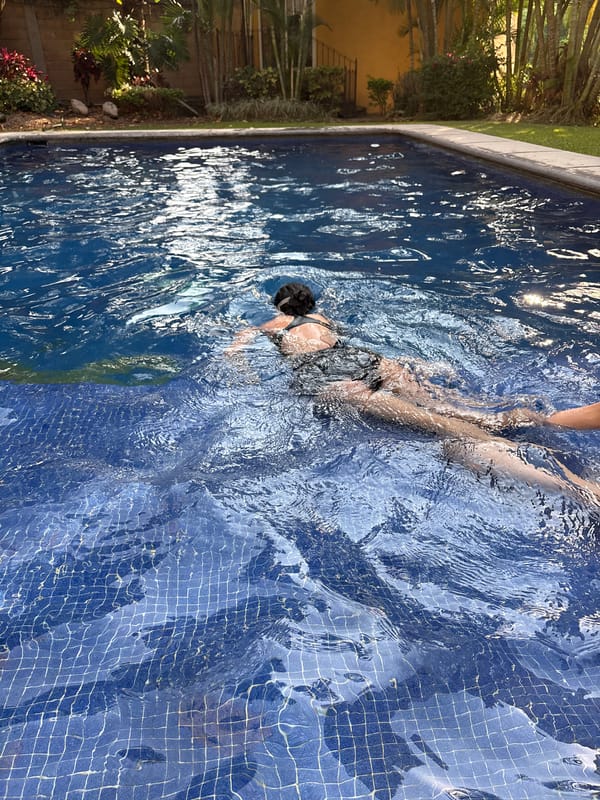 Woman swims in blue-tiled pool in Cuernavaca, Mexico
