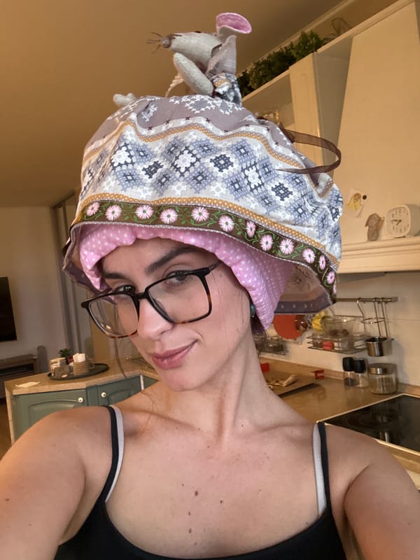 Woman and cloth mouse doll spotted in kitchen setting