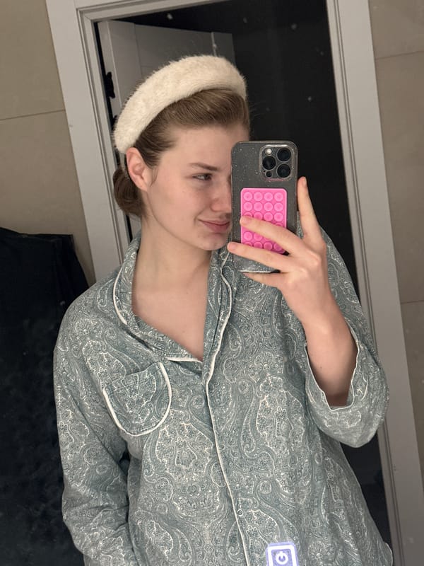 Woman takes mirror selfie in pajamas in Kazan