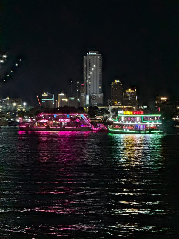 Illuminated tour boats cruise Han River in nighttime Đà Nẵng
