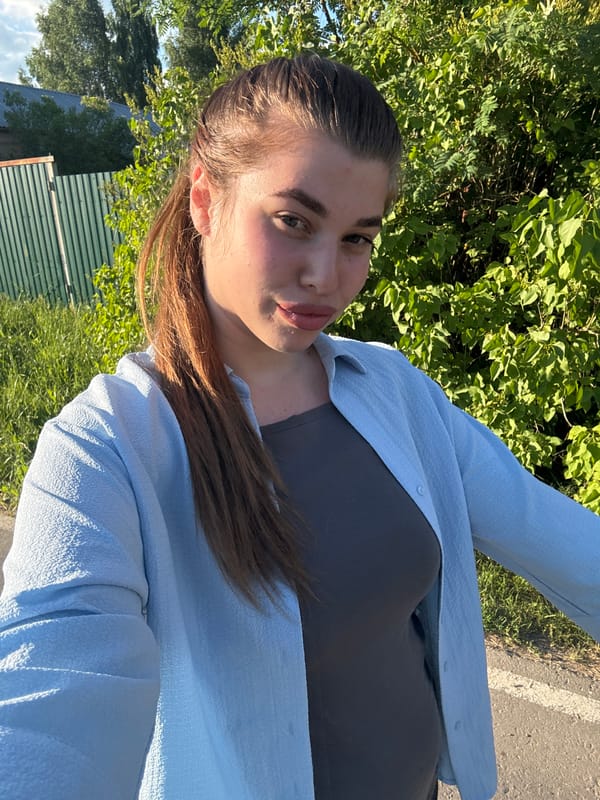 Outdoor portrait in layered blue and grey tops.