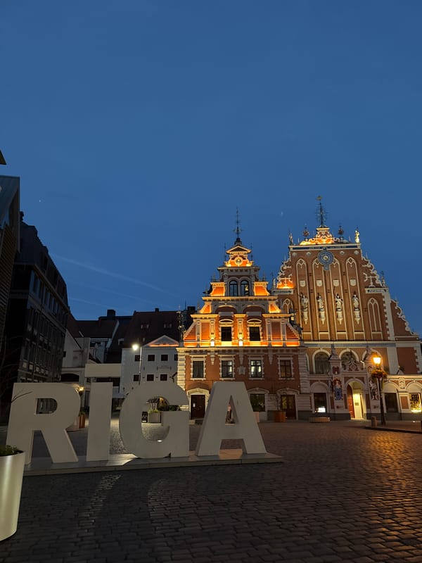 Riga's Old Town at twilight — architecture, roses, and live music
