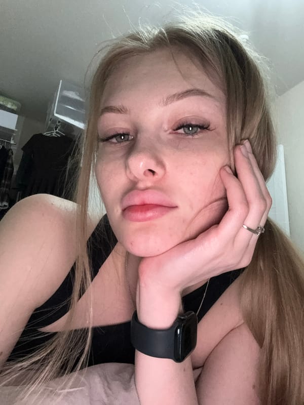 Young woman takes playful selfies indoors in Perm, Russia