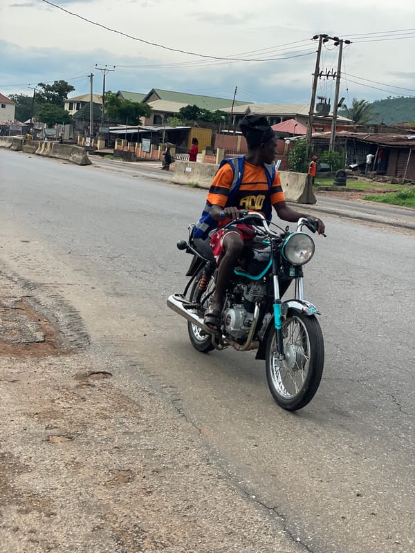 Morning street life along a wet road in Lokoja, Nigeria