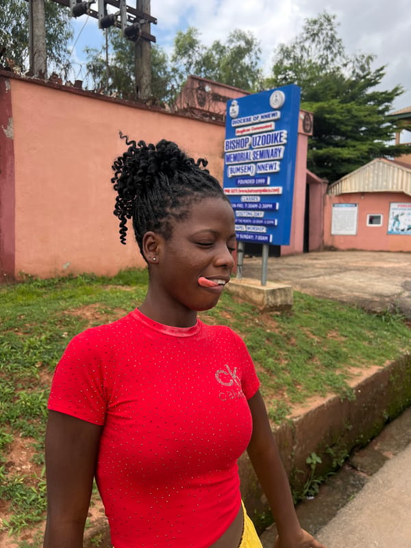 Joyful poses near a yellow auto-rickshaw in Nnewi