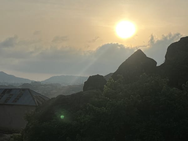 Morning scenes from Jos Nigeria show rocky settlements and cats