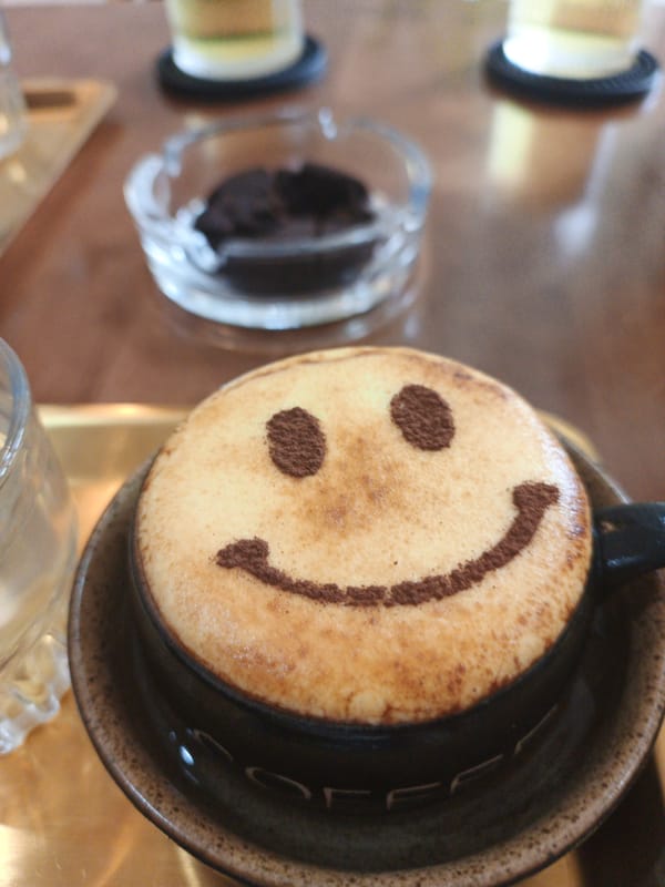 Cocoa-dusted latte art at a Nha Trang café