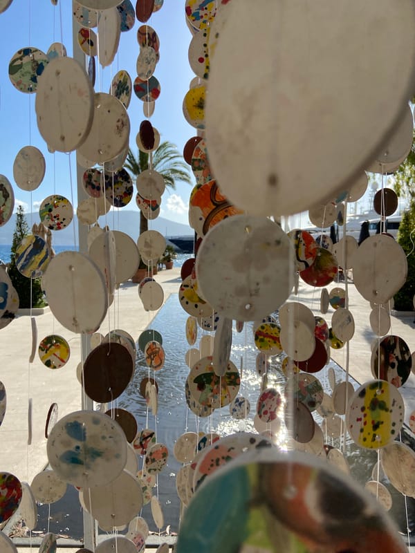 Tourist documents public art and street scenes in Tivat