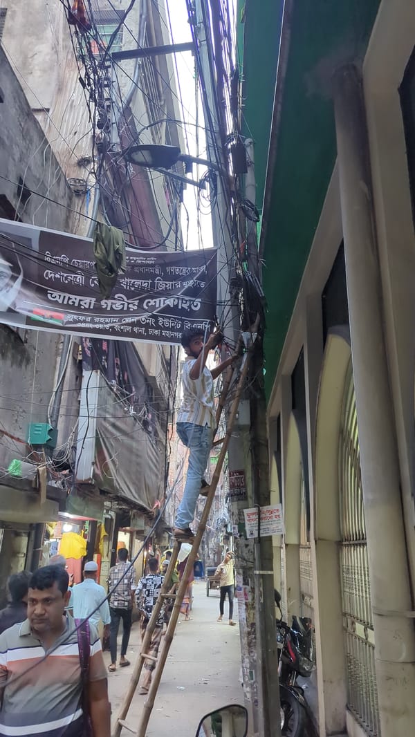 Electrical repair work on busy Dhaka street