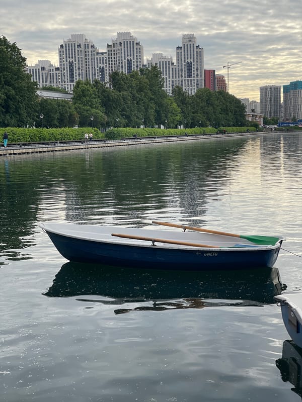 Urban waterfront with boat rentals, trams, and pedestrians documented