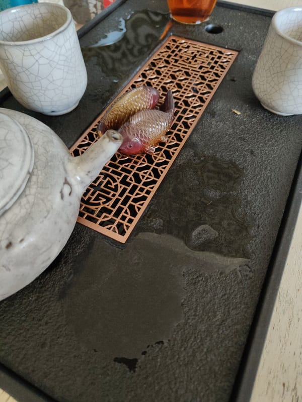Traditional tea ceremony setup captured with white teapot and cups