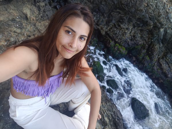 Woman photographs coastal visit in Pedro González, Venezuela