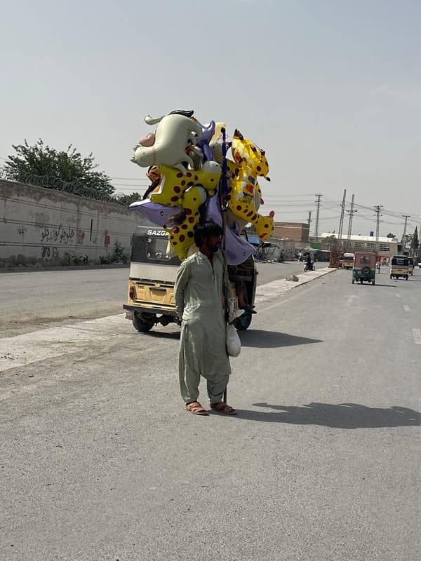 Balloon vendor pushes cart through Quetta streets