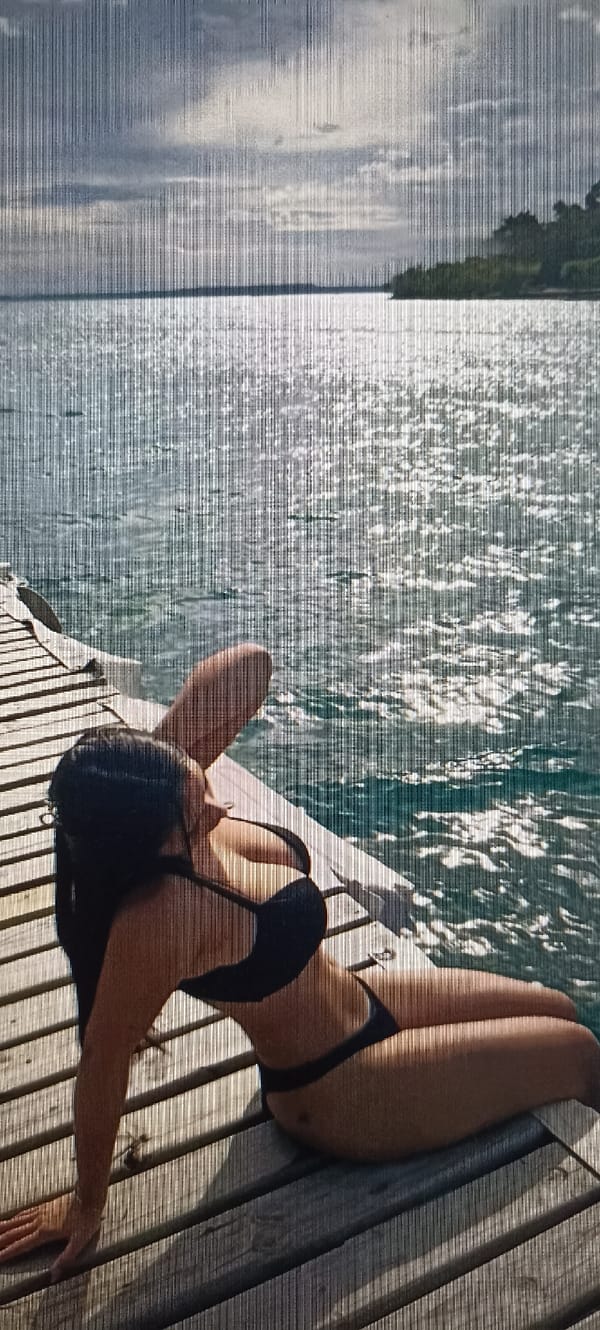 Relaxing by the water's edge in a black bikini
