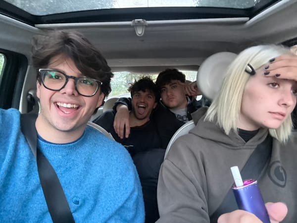 Five people photographed from above inside car in Milan