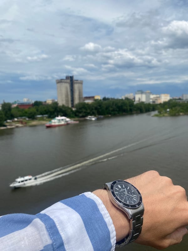 Watch held up over Samara's riverfront skyline