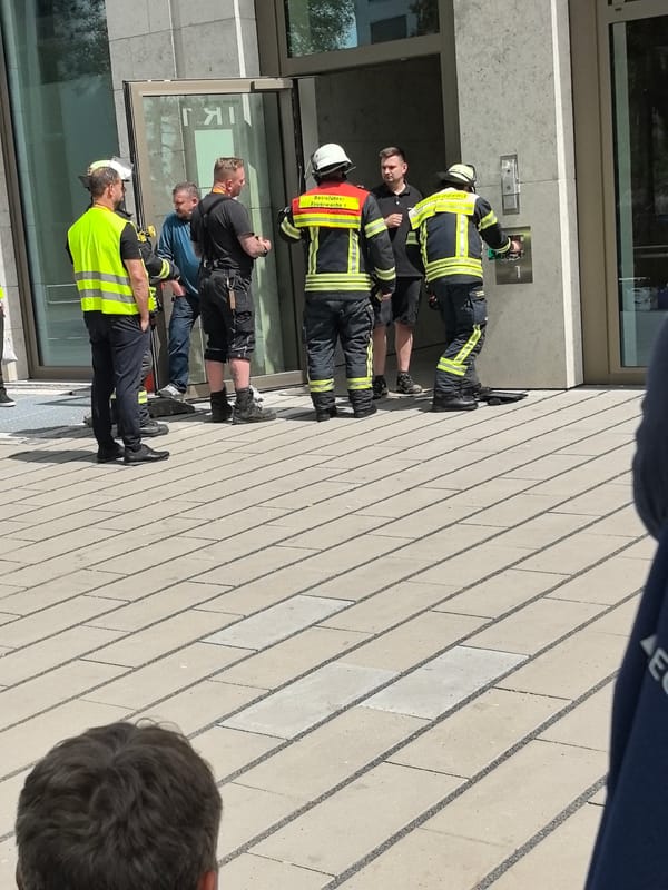 Firefighters gather near building entrance in Wiesbaden