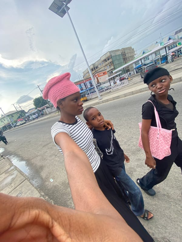 Two women in distinctive hats walk city streets