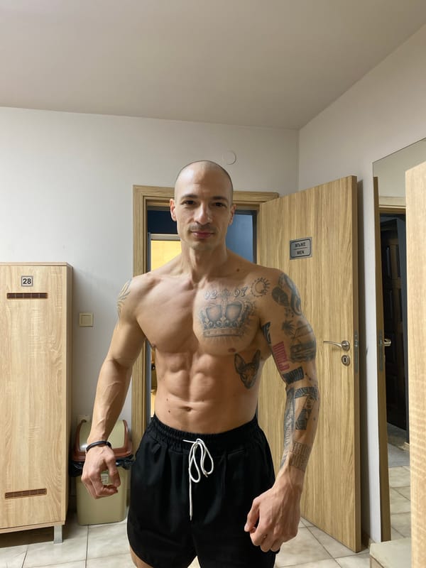 Tattooed man poses shirtless in Pleven locker room