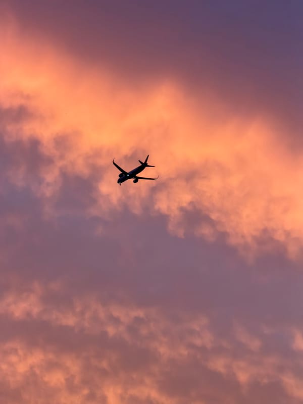 Aircraft spotted over Delhi rooftops during sunset near airport