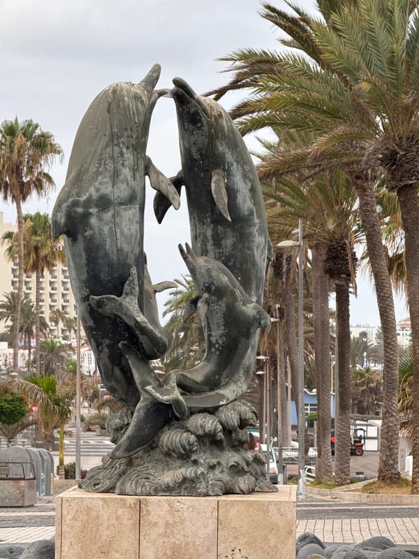 Weathered bronze dolphin sculpture in Adeje, Tenerife