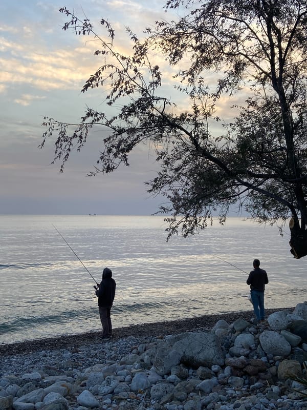 Two people fish along Bar Montenegro coast