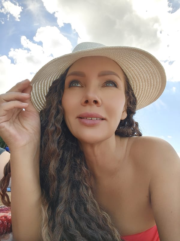Lazy beach afternoon, sun hat on, sky above