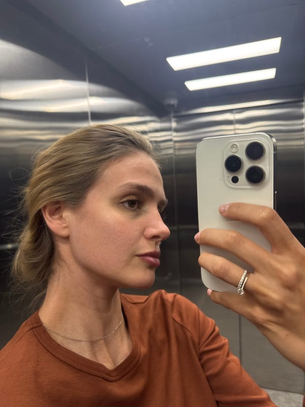 Woman Takes Selfie in Stainless Steel Elevator