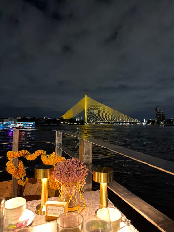 Rama VIII Bridge glowing over Bangkok's Chao Phraya at night