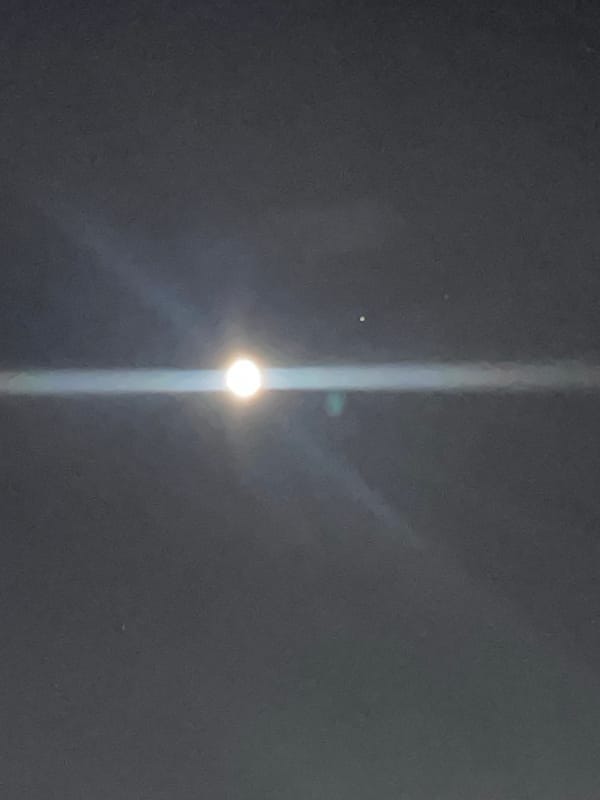 Bright light creates streaks over cloudy Bavra sky