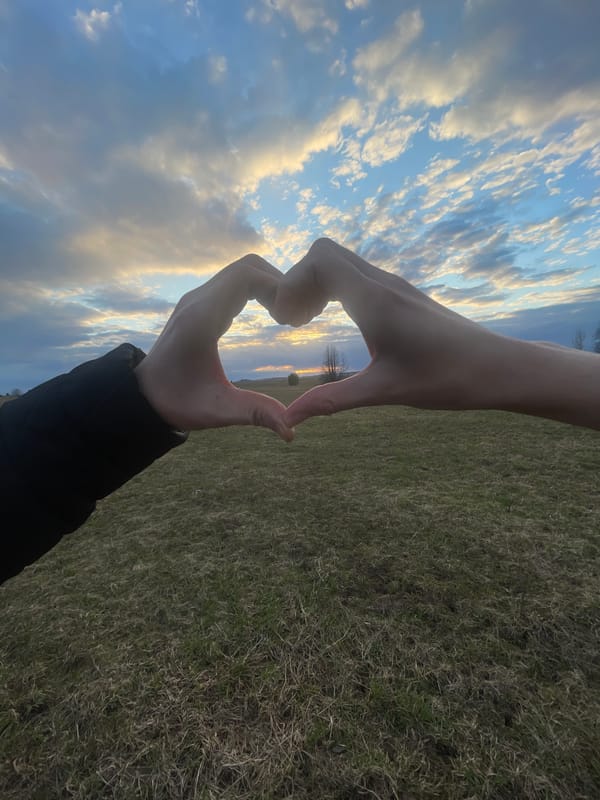 Heart gesture photographed against sky in Kuyeda, Russia