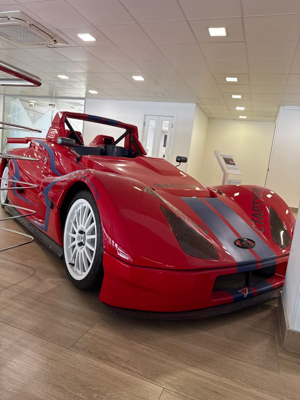 Red racing car displayed, bridge traffic observed Friday morning