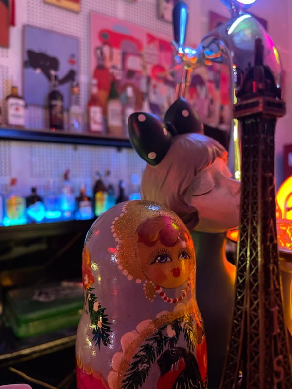 Inside a neon-lit bar in Đà Nẵng on a July night