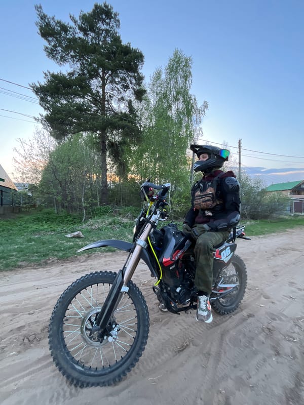 Motorcyclist rides dirt bike through rural Chaikovsky roads