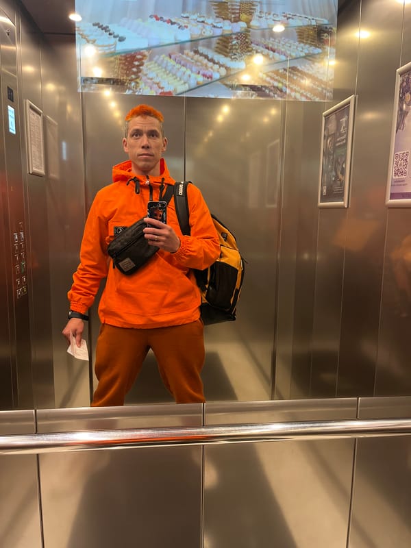 Orange-clad man with phone, ticket observed in Moscow elevator
