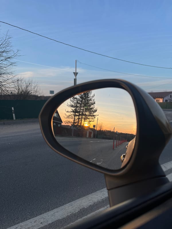 Sunset captured in car mirror reflection in Zaovrazh'e
