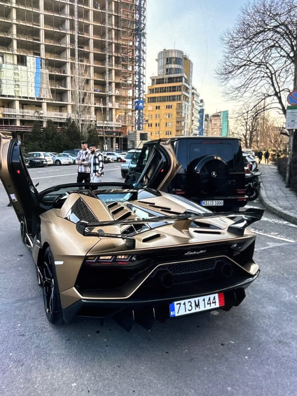 Luxury vehicles including gold Lamborghini spotted on urban street