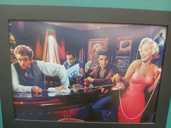 Eclectic framed wall art in what looks like a tattoo parlor