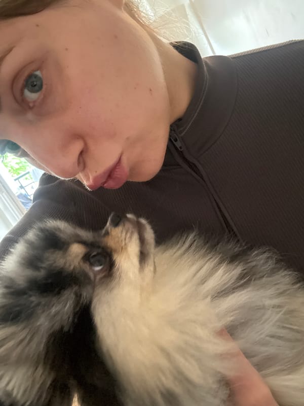 Person and small dog photographed in intimate moments, Paris