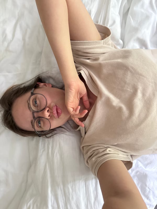 Woman takes selfies on bed in Czech mountain town