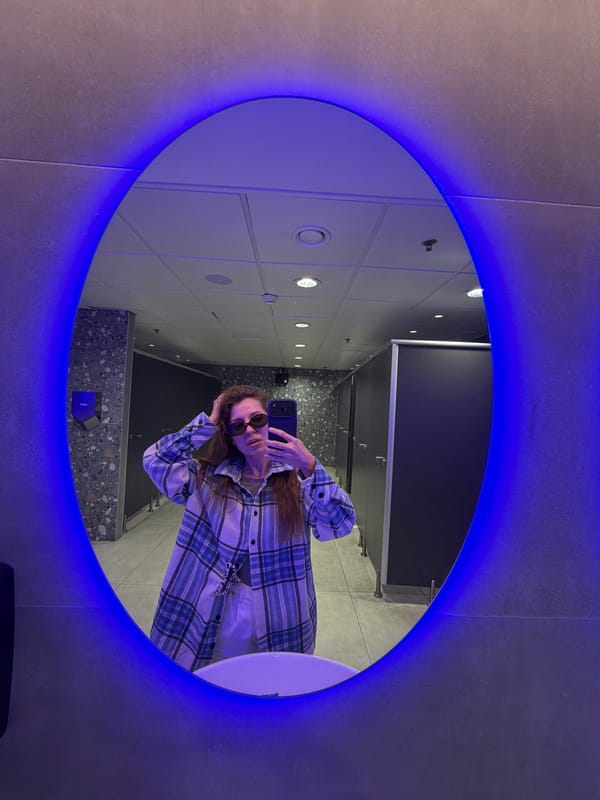 Woman takes selfie in LED-lit restroom mirror in Israel