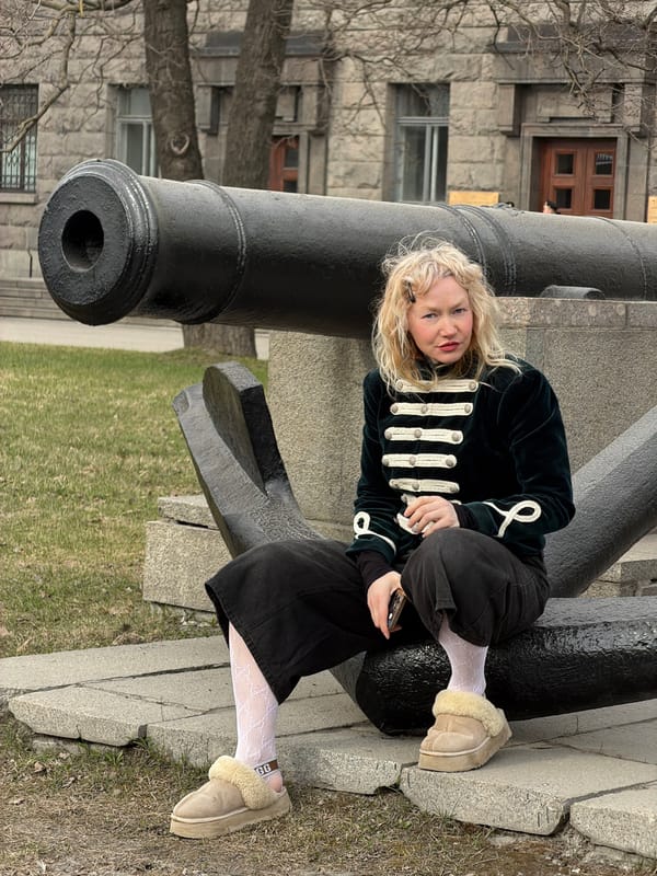 Woman poses with historic cannon in Saint Petersburg