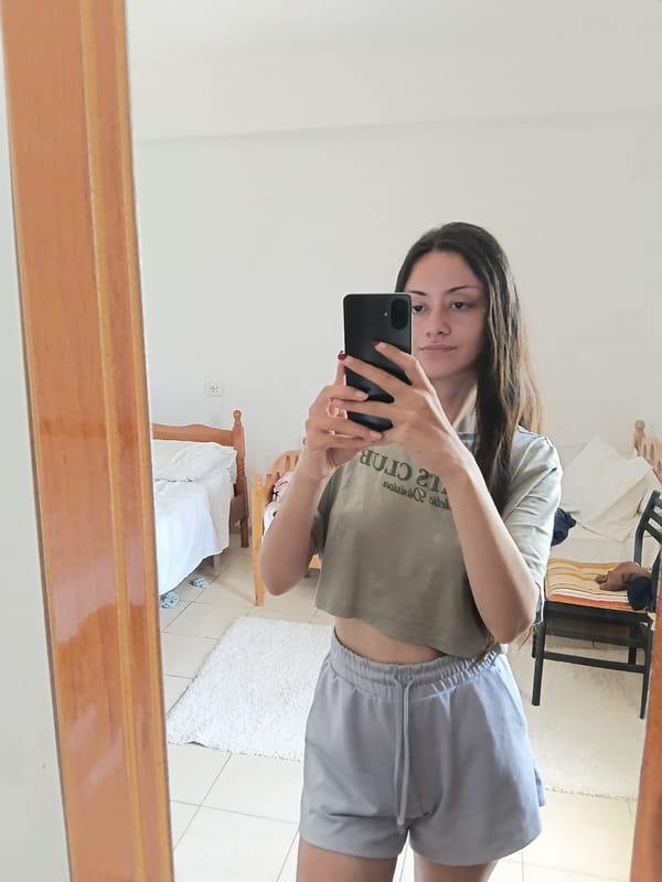 Woman takes multiple mirror selfies in Vlora bedroom